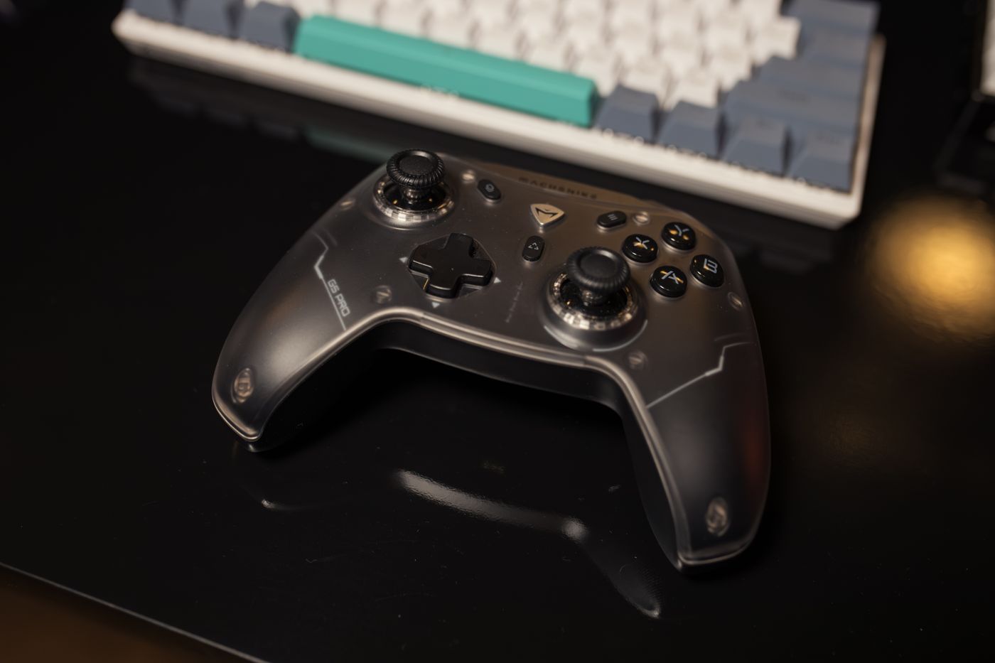 Black game controller on a dark desk